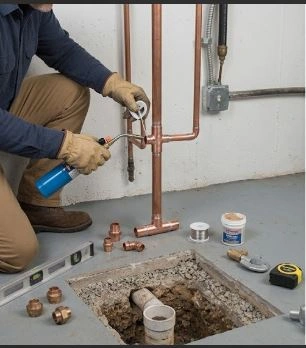 Water Line Installation Montreal — licensed plumber connecting refrigerator ice maker water line